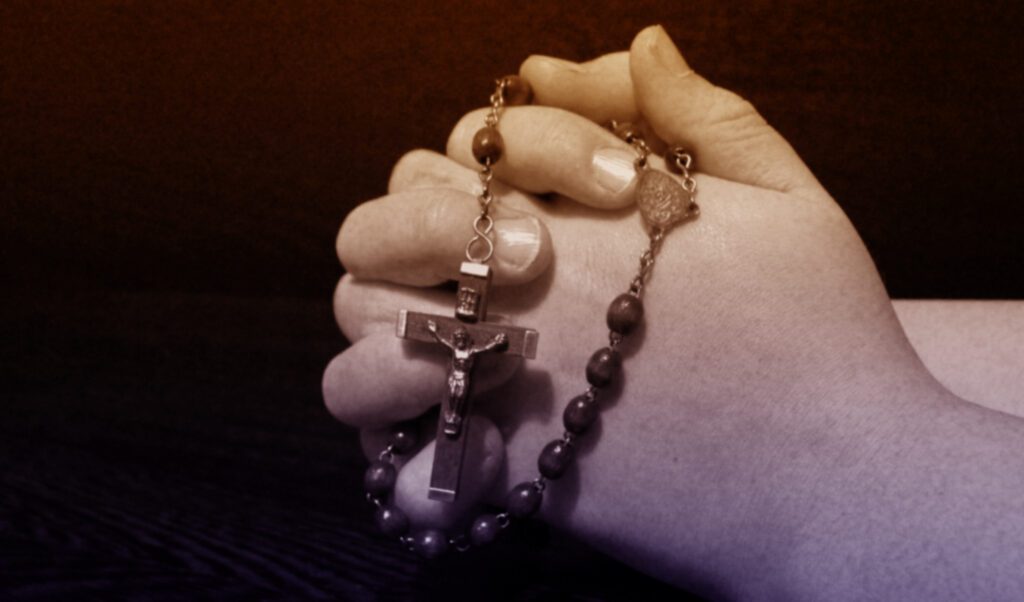 praying hands with rosary